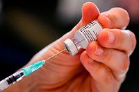 A nurse prepares a dose of the Pfizer-BioNTech Covid-19 vaccine, during a vaccination operation at the "Woonzorgcentrum Sint-Pieters" rest home on December 28, 2020 in Puurs, in Belgium's Flemish region, as the country starts its national vaccination campaign to fight against the spread of the novel coronavirus. - The vaccine doses were transported earlier from the University Hospital in Leuven to the residential care home, as the vaccination program starts with the most vulnerable. Belgium is the country with the highest number of deaths compared to its population with 165 fatalities per 100,000 inhabitants. (Photo by Dirk WAEM / POOL / AFP)