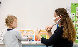 Vanessa Andrieu, teacher of French sign language (LSF) gives a lesson to deaf pupils in her classroom at Sajus school, on December 4, 2020 in Ramonville in the suburbs of Toulouse, with an inclusive mask due to the Covid-19 pandemic. (Photo by Fred SCHEIBER / AFP)