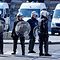 Belgian police offiers wearing protective gears stand at the site of unrests in Anderlecht, Brussels, on April 11, 2020. - People gather in a reaction to the death of a 19-year-old young man, who died after his scooter collided with a police car during a chase the night before. (Photo by OLIVIER GOUALLEC / various sources / AFP) / Belgium OUT