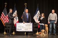 (FILES) In this file photo taken on January 29, 2016, then Republican presidential candidate Donald Trump (C) joins Jerry Falwell, Jr.(L), president of Liberty University, for a campaign rally at the Adler Theatre where Trump presented a check from the Trump Foundation to the Puppy Jake on January 30, 2016 in Davenport, Iowa. - President Donald Trump has agreed to shut down his personal charity, the Trump Foundation, which has been accused of engaging in "persistently illegal conduct," the New York attorney general said on December 18, 2018. (Photo by SCOTT OLSON / GETTY IMAGES NORTH AMERICA / AFP)