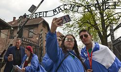 People take selfies outside 'Arbeit Macht Frei' sign near the main entrance gate to Auschwitz I.
Under the theme 'Say No To Anti-Semitism' over 10,000 of young Jewish and non-Jewish youth from 40 countries participate in the the 31st annual International March of the Living between the former Nazi concentration camp Auschwitz I and Auschwitz - Birkenau to pay tribute to all victims of the Holocaust and call for an end to anti-Semitism..  
On Thursday, May 2, 2019, in Auschwitz Nazi Concentration Camp, Oswiecim, Poland. (Photo by Artur Widak/NurPhoto via Getty Images)