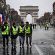 Protesters wearing yellow vests (gilets jaunes) demonstrate on the Champs-Elysees in Paris, on December 15, 2018 against rising costs of living they blame on high taxes. - The "Yellow Vests" (Gilets Jaunes) movement in France originally started as a protest about planned fuel hikes but has morphed into a mass protest against President's policies and top-down style of governing. (Photo by CHRISTOPHE ARCHAMBAULT / AFP)