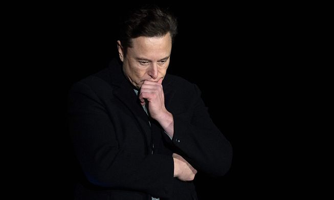 Elon Musk pauses and looks down as he speaks during a press conference at SpaceX's Starbase facility on 10 February 2022 