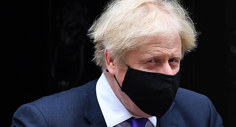 Britain's Prime Minister Boris Johnson wearing a face mask because of the coronavirus pandemic leaves number 10 Downing Street in central London on December 2, 2020, to take part in the Prime Minister Question (PMQs) session in the House of Commons. - Britain's Prime Minister Boris Johnson on Wednesday hailed UK approval for the use of Pfizer-BioNTech's Covid-19 vaccine as "fantastic" news that would help life get back to normal. "It's the protection of vaccines that will ultimately allow us to reclaim our lives and get the economy moving again," he said, after regulators gave the green light in a world first. (Photo by JUSTIN TALLIS / AFP)