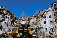 Rescue teams in the rubble of a bombed-out building on March 2 in the city of Zaporizhzhia. 