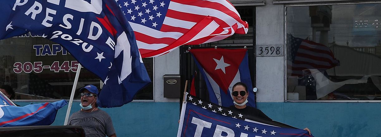 (FILES) In this file photo taken on October 18, 2020, a caravan of supporters for Democratic presidential nominee Joe Biden drives past supporters of President Donald Trump standing on a sidewalk during a Worker Caravan for Biden event in Miami, Florida. - New applications for US jobless benefits fell for a second straight week last week, the Labor Department said on October 29, 2020, as the world's largest economy continues to recover from the coronavirus downturn. The 751,000 new claims were 40,000 below the previous week's result and the lowest since business shutdowns sent claims spiking in March, indicating a renewed loss of momentum in the unemployment indicator. (Photo by JOE RAEDLE / GETTY IMAGES NORTH AMERICA / AFP)