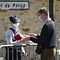 A man hands flowers to police officers to be taken down to the police station where a police official was stabbed death Friday in Rambouillet, south-west of Paris, on April 25, 2021. - French prosectors opened a terror probe after a woman working for the police was stabbed to death in Rambouillet, a well-heeled usually peaceful commuter town about 60 kilometres (40 miles) from Paris. The attack revived the trauma of a spate of deadly attacks last year in France blamed on Islamist radicals. (Photo by Bertrand GUAY / AFP)