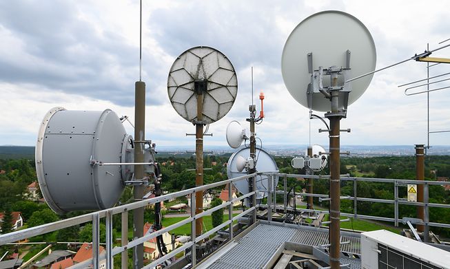 Directional radio antennas and television antennas are installed on an old water tower in the German city of Dresden, where Vodafone is building its 5G network.