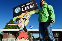 (FILES) In this file photo taken on September 25, 2015 an activist holds up a sign reading "No more lies" during a protest of environmental watchdog Greenpeace in front of the headquarters of German car maker Volkswagen in Wolfsburg, central Germany. - Car behemoth Volkswagen will face a German court on September 30, 2019 as hundreds of thousands of owners of manipulated diesel cars demand compensation four years after the country's largest post-war industrial scandal erupted. (Photo by John MACDOUGALL / AFP)