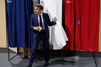 TOPSHOT - France's President Emmanuel Macron leaves the polling booth to casts his vote in French parliamentary elections at a polling station in Le Touquet, northern France on June 12, 2022. (Photo by Ludovic MARIN / POOL / AFP)