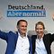 Parliamentary group co-leader of Germany's far-right Alternative for Germany (AfD) party Alice Weidel (R) and the party's co-leader Tino Chrupalla, both the party's top candidates in the upcoming election, wave to supporters at the end of a rally of the AfD party for the launch of the electoral campaign ahead of the September 26 federal elections, in Schwerin, northern Germany, on August 10, 2021. (Photo by John MACDOUGALL / AFP)