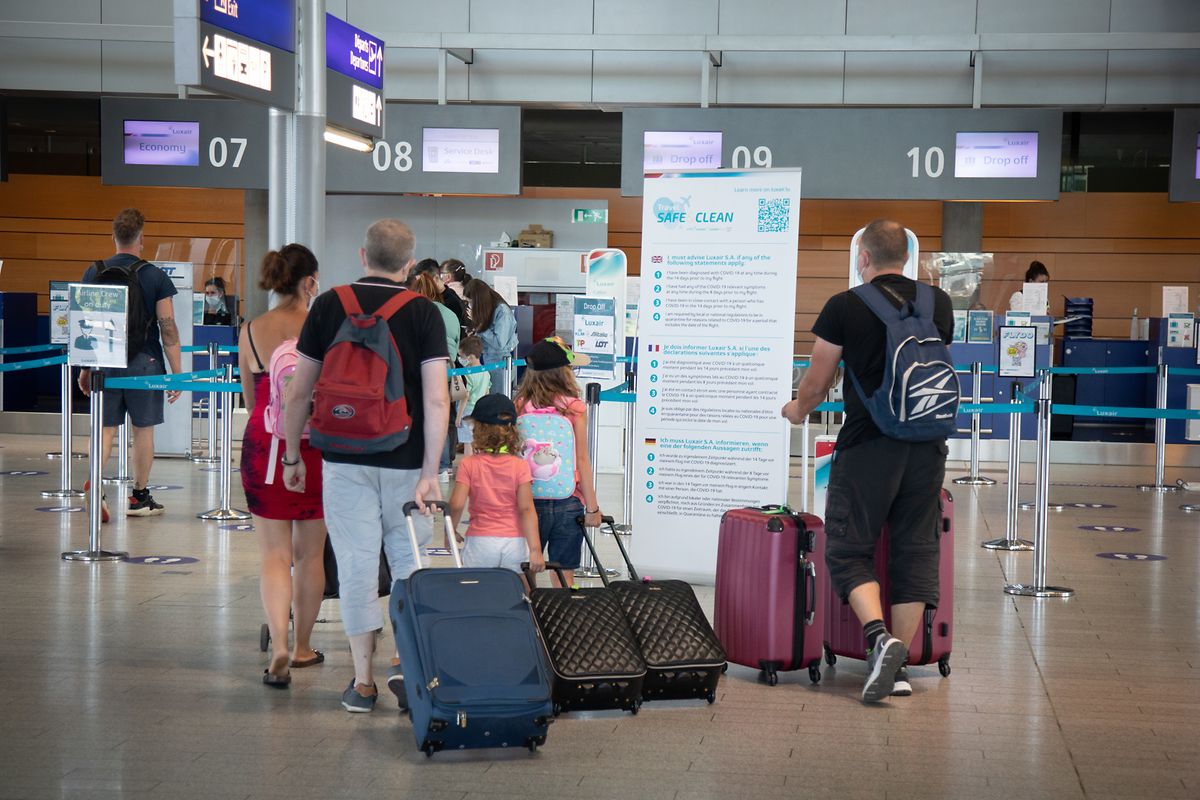 A family gets ready to board a flight at Luxembourg's Findel airport in 2021