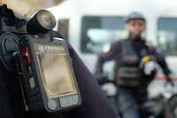 A police officer stands guard with a body camera attached to the shoulder on February 15, 2017 in Marseille.
Currently in Marseille, only the Mountain bike brigade of the city center and the Specialised field brigade (BST - Brigade specialisee de terrain) of the northern district are equipped with body cameras. Testing of the cameras began 3 years ago in France. According to th prefect of police of the Bouches-du-Rhone, Laurent Nunez, the body cameras "reduce the tensions during interventions". / AFP PHOTO / BORIS HORVAT