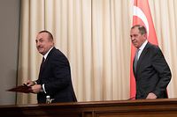 Russian Foreign Minister Sergei Lavrov and his Turkish counterpart Mevlut Cavusoglu hold a joint press conference following the talks on a ceasefire deal between the warring sides in Libya, in Moscow on January 13, 2020. (Photo by Pavel Golovkin / POOL / AFP)