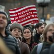 People hold signs as the Council on American Islamic Relations holds a protest against President Donald Trump's planned ban on Muslim travel in Washington Square Park in New York on January, 25, 2017.  / AFP PHOTO / Bryan R. Smith