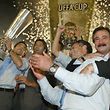 José Mourinho, Porto manager at the time, being hugged by Reinaldo Teles and Deco holding the UEFA Cup won in Seville in 2004. 