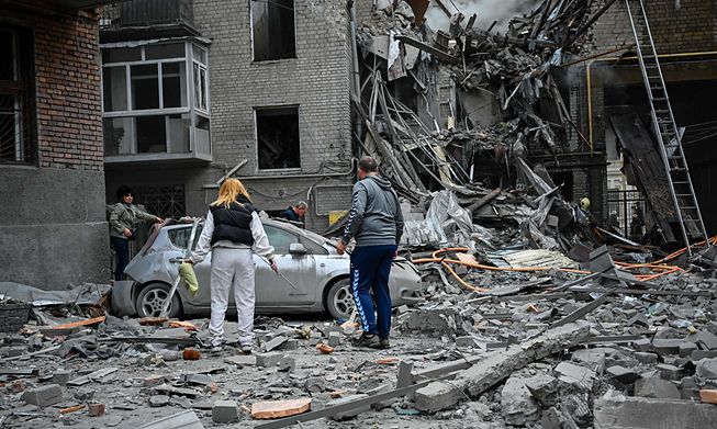 ocal residents stand amid the rubble of an apartment after it was hit by a missile strike in Kharkiv, on September 6, 2022, amid the Russian invasion of Ukraine.
