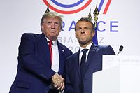 France's President Emmanuel Macron (R) and   US President Donald Trump embrace during a joint-press conference in Biarritz, south-west France on August 26, 2019, on the third day of the annual G7 Summit attended by the leaders of the world's seven richest democracies, Britain, Canada, France, Germany, Italy, Japan and the United States. (Photo by ludovic MARIN / AFP)