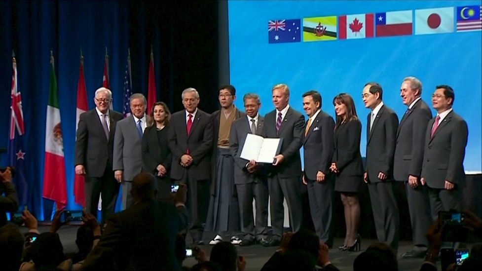 Trade ministers and officials from the 12 TPP member nations are seen at the signing ceremony in Auckland, New Zealand.
