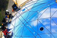 Workers scale on one of the spheres of Brussels' Atomium during a site cleaning September 28, 2012. The 102-metre (335 feet) tall structure and its nine spheres symbolise a crystal molecule of metal with its atoms being magnified about 165 billion times. The cleaning of the Atomium, which was designed for the 1958 International Exhibition of Brussels and which received a multimillion-dollar facelift in 2006, will run for a full month. A team of five specialised workers take about three days to clean a ball, each of which has a surface area of 1000 square metres (10,764 square feet). REUTERS/Yves Herman (BELGIUM - Tags: SOCIETY)