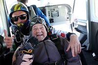 103-year-old Rut Larsson from Mj�lby and her tandem partner Joackim Johansson from Link�ping's parachute club pose for a picture before their jump in Motala, Sweden, on May 29, 2022. - The 103-year-old Swedish woman set the world record for the oldest person to complete a tandem parachute jump, saying she planned to celebrate "with a little cake". Larsson, who is 103 years and 259 days old, beat the previous record of 103 years and 181 days. (Photo by Jeppe GUSTAFSSON / TT News Agency / AFP) / Sweden OUT