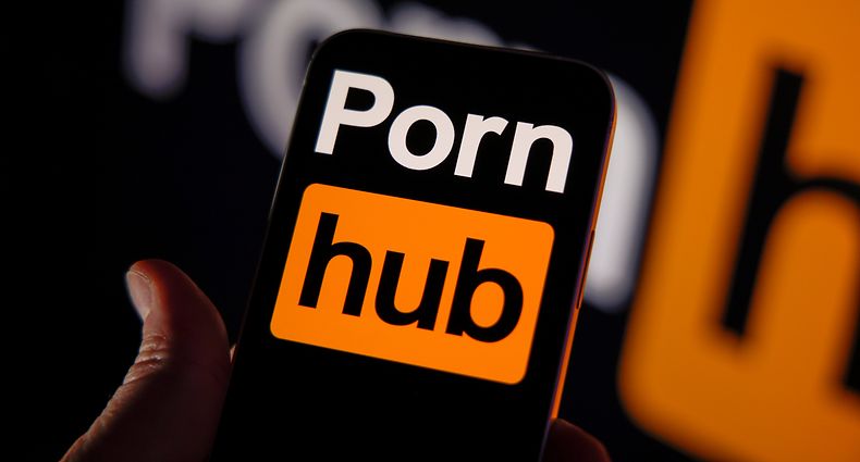 The Pornhub logo is seen on an iPhone mobile device in this illustration photo in Warsaw, Poland on 12 October, 2022. The world's largest website will monitor more than 28 thousand keywords that may signal illegal activity together with the help of child abuse charity organizations. (Photo by Jaap Arriens / Sipa USA)No Use Germany.