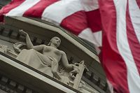 (FILES) File photo taken on July 27, 2017 shows the US national flag flying over a statue on the Department of Justice in Washington, DC.
Deputy Attorney General Rod Rosenstein announced July 13, 2018 that twelve Russian intelligence officers have been indicted by a grand jury for hacking Democratic Party emails ahead of the 2016 US presidential election. The indictment was drawn up by Special Counsel Robert Mueller, the former FBI director who is looking into Russian interference in the November 2016 vote. / AFP PHOTO / ANDREW CABALLERO-REYNOLDS