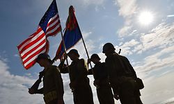 US soldiers dressed in WWII US military uniforms stand guard during a ceremony on Omaha Beach in Saint-Laurent-sur-Mer, western France on June 5, 2019, in homage to Native American who took part in the D-Day landings of World War II. (Photo by LOIC VENANCE / AFP)