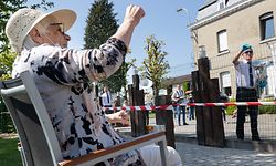 Residents of the elderly home Pannesheydt listen to musicians during a mini-concert in Montzen on April 26, 2020 on the sixth week of confinement in the ongoing coronavirus crisis. - The government has announced a phased plan to attempt an exit from the lockdown situation in the country, continuing to avoid the spread of Covid-19. (Photo by BENOIT DOPPAGNE / BELGA / AFP) / Belgium OUT