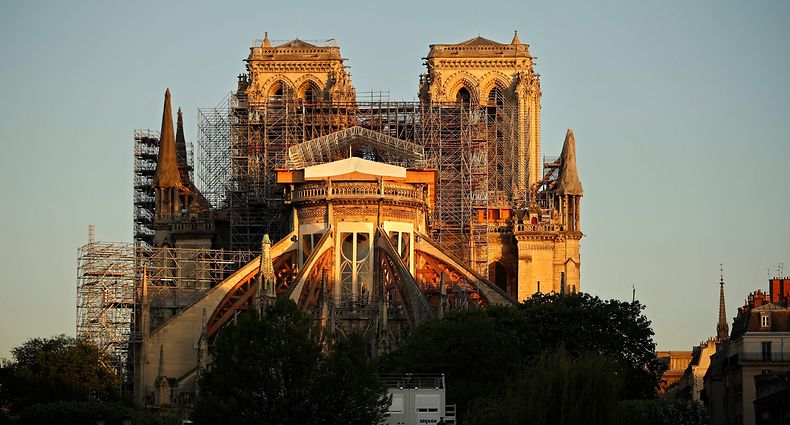 (FILES) A file photo taken on April 14, 2020 shows the Paris' Cathedral Notre Dame at the sunrise on the eve of the first anniversary of the violent fire who destroyed a large part of the monument, on the twenty-nineth day of a lockdown in France to stop the spread of the  COVID-19, (the novel coronavirus). - New French Minister of Culture Roselyne Bachelot estimated on July 9, 2020 that a "broad consensus" existed to reconstruct "identically" the spire of Notre-Dame de Paris cathedral, while an advisory committee will meet on the same day to discuss the matter. (Photo by THOMAS COEX / AFP)