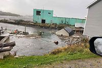 This September 24, 2022, image courtesy of Michael King, special advisor to Newfoundland and Labrador Premier Andrew Furey, and his family, shows damaged caused by post-tropical storm Fiona on the Burnt Islands, in the Newfoundland and Labrador Province of Canada. - Fiona knocked out power to more than 500,000 households as it lashed eastern Canada with strong winds and heavy rain on Saturday, electricity providers said.  In the province of Novia Scotia alone, at least 400,000 households lost electricity after Fiona, downgraded from a hurricane to a post-tropical storm but still packing winds of 85 miles (137 kilometers) per hour, made landfall, Novia Scotia Power reported. (Photo by Handout / Michael King / AFP) / RESTRICTED TO EDITORIAL USE - MANDATORY CREDIT "AFP PHOTO / Michael King" - NO MARKETING NO ADVERTISING CAMPAIGNS - DISTRIBUTED AS A SERVICE TO CLIENTS