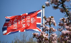 A Keep Calm and Carry On flag flies in the garden of a home in Bodiam, southern England, on April 9, 2020 as Britain continued to battle the outbreak of new coronavirus and the governement prepared to extend the nationwide lockdown. - The disease has struck at the heart of the British government, infected more than 60,000 people nationwide and killed over 7,000, with another record daily death toll of 938 reported on April 8. (Photo by Ben STANSALL / AFP)