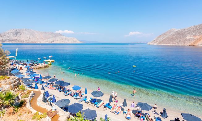 Holidaymakers on a beach in Greece