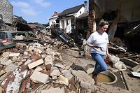 A resident walks among the destroyed buildings in Pepinster, near Liege, on July 19, 2021, following heavy rains and flooding across areas of France, Belgium, Germany and The Netherlands. - Rescue workers scrambled to find survivors and victims of the devastation wreaked by the worst floods to hit western Europe in living memory, which have already left more than 150 people dead and dozens more missing. (Photo by JOHN THYS / AFP)