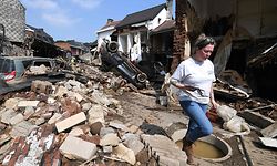 A resident walks among the destroyed buildings in Pepinster, near Liege, on July 19, 2021, following heavy rains and flooding across areas of France, Belgium, Germany and The Netherlands. - Rescue workers scrambled to find survivors and victims of the devastation wreaked by the worst floods to hit western Europe in living memory, which have already left more than 150 people dead and dozens more missing. (Photo by JOHN THYS / AFP)