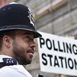 A police officer stands on duty outside a polling station in Tower Hamlets, London, Britain June 8, 2017. REUTERS/Hannah McKay     TPX IMAGES OF THE DAY