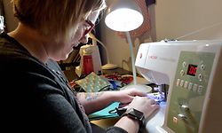 Stephanie Cave sews the mask seems and straps together to finish creating masks at Stitch House on March 22, 2020 in Dorchester, Massachusetts. - From amateur seamstresses and sewing clubs to Hollywood costume-makers, a patchwork army of volunteers across the United States is churning out gowns and masks for emergency workers battling coronavirus.
The pandemic that has killed 2,500 nationwide has left medics dangerously exposed to the virus, with doctors forced to reuse scarce masks through the day as hospital supplies of personal protective equipment (PPE) rapidly dwindle. (Photo by Joseph Prezioso / AFP)