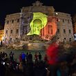 A Belgian flag is display on the Trevi Fountain in Rome on March 22, 2016 in tribute to the victims of Brussels following triple bomb attacks in the Belgian capital that killed about 35 people and left more than 200 people wounded. 
Belgium launched a huge manhunt on March 22 after a series of bombings claimed by the Islamic State group ripped through Brussels airport and a metro train, killing around 35 people in the latest attack to bring carnage to the heart of Europe. / AFP PHOTO / GABRIEL BOUYS