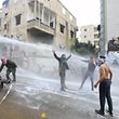 Lebanese security forces use a water hose to disperse protestors during a demonstration outside the US embassy in Awkar, on the outskirts of the Lebanese capital Beirut, on December 10, 2017, to protest against Washington's decision to recognise Jerusalem as the capital of Israel. / AFP PHOTO / ANWAR AMRO