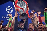 (FILES) In this file photo taken on June 1, 2019 Liverpool's German manager Jurgen Klopp (C) raises the trophy after winning the UEFA Champions League final football match between Liverpool and Tottenham Hotspur at the Wanda Metropolitano Stadium in Madrid. - Twelve of Europe's most powerful clubs announced the launch of a breakaway European Super League on April 19, 2021 in a potentially seismic shift in the way football is run, but faced accusations of greed and cynicism. Six Premier League teams, Liverpool, Manchester United, Arsenal, Chelsea, Manchester City and Tottenham are involved, alongside Real Madrid, Barcelona, Atletico Madrid, Juventus, Inter Milan and AC Milan. Real Madrid chief Florentino Perez, who was announced as the first ESL president, said the breakaway reflected the big clubs' wishes. (Photo by Ben STANSALL / AFP)
