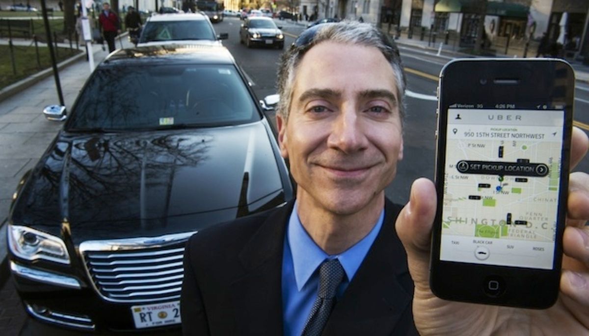 Peter Faris, CEO of Szabo Faris LLC Transportation Solutions, stands in front of one of his vehicles while holding a smart phone with an app that orders up his sedan service February 14, 2013 in Washington, DC. Faris, an independent driver who works with Uber, a technology firm which has created a mobile app which allows consumers to use their device to request a nearby taxi or limousine. Uber is among a number of apps which are being deployed in cities in the United States and worldwide. AFP Photo/Paul J. Richards (Photo credit should read PAUL J. RICHARDS/AFP/Getty Images)