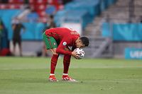 Ronaldo kisses the ball before scoring a penalty in the Euro 2020 group stage game against France in Hungary.