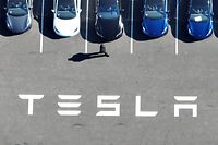 FREMONT, CALIFORNIA - OCTOBER 19: In an aerial view, brand new Tesla cars sit in a parking lot at the Tesla factory on October 19, 2022 in Fremont, California. Electric car maker Tesla will report third quarter earnings today after the closing bell.   Justin Sullivan/Getty Images/AFP