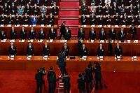TOPSHOT - State media staff members work as China's President Xi Jinping (C) and other Chinese leaders arrive for the opening session of the National People's Congress (NPC) at the Great Hall of the People in Beijing on March 5, 2023. (Photo by NOEL CELIS / AFP)