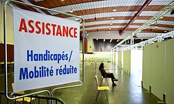 A person waits at the vaccination centre Hall Victor Hugo in Luxembourg, on January 21, 2021, during a vaccination campaign aimed at curbing the spread of the Covid-19 pandemic. (Photo by JEAN-CHRISTOPHE VERHAEGEN / AFP)