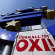 A placard that reads "OXI is everywhere!" is seen on a Euro sign during a Blockupy demonstration at the former headquarters of the European Central Bank (ECB) in Frankfurt, Germany, July 3, 2015. According to Blockupy, whose motto is "Nein, Oxi, No - to austerity - Yes to democracy", about 200 demonstrators protested prior to the national referendum in Greece on Sunday.  REUTERS/Ralph Orlowski