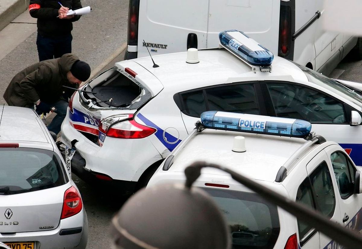 Police inspect damage after a collision between police cars at the scene after a shooting at the Paris offices of Charlie Hebdo, a satirical newspaper, January 7, 2015. Eleven people were killed and 10 injured in shooting at the Paris offices of the satirical weekly Charlie Hebdo, already the target of a firebombing in 2011 after publishing cartoons deriding Prophet Mohammad on its cover, police spokesman said. Five of the injured were in a critical condition, said the spokesman. Separately, the government said it was raising France's national security level to the highest notch. REUTERS/Christian Hartmann (FRANCE - Tags: CRIME LAW MEDIA)