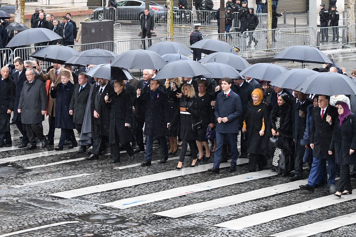 (From2ndL) President of the European Commission Jean-Claude Juncker, Lithuania's President Dalia Grybauskaite, Denmark's Prime Minister Lars Lokke Rasmussen, Morocco's Prince Moulay Hassan, Moroccan King Mohammed VI, German Chancellor Angela Merkel, French President Emmanuel Macron and his wife Brigitte Macron, Canadian Prime Minister Justin Trudeau, Turkish President's wife Emine Erdogan and Niger's President's Lalla Malika Issoufou arrive at the Arc de Triomphe in Paris on November 11, 2018 to attend a ceremony as part of commemorations marking the 100th anniversary of the 11 November 1918 armistice, ending World War I. (Photo by Eric FEFERBERG / AFP)