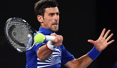 Serbia's Novak Djokovic hits a return against France's Lucas Pouille during their men's singles semi-final match on day 12 of the Australian Open tennis tournament in Melbourne on January 25, 2019. (Photo by Paul Crock / AFP) / -- IMAGE RESTRICTED TO EDITORIAL USE - STRICTLY NO COMMERCIAL USE --
