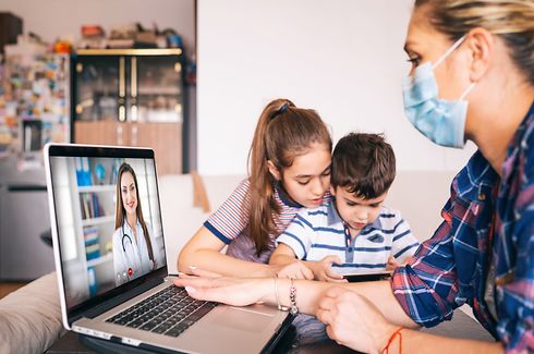 Mother trying to talk with doctor on laptop while watching two kids.Family in isolation covid-19
